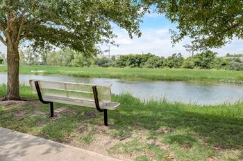 A park bench sitting next to a river